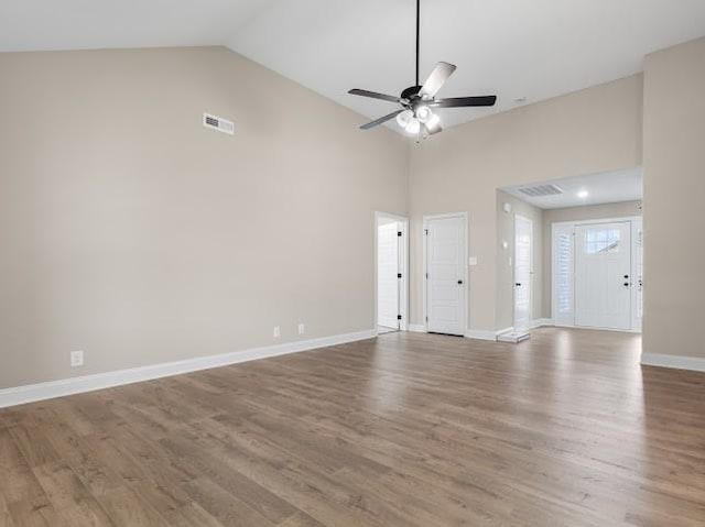 unfurnished living room with wood-type flooring, ceiling fan, and high vaulted ceiling