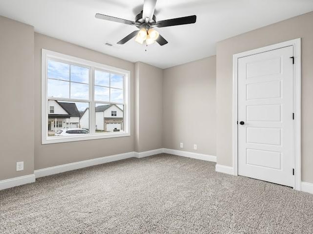 carpeted empty room with ceiling fan