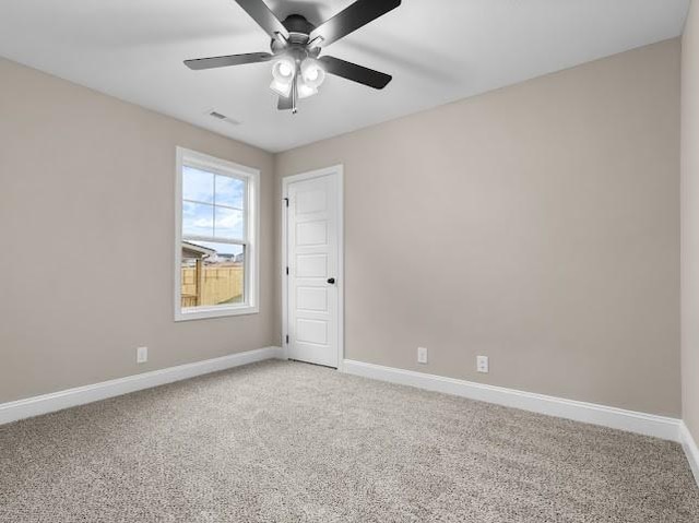 carpeted spare room featuring ceiling fan