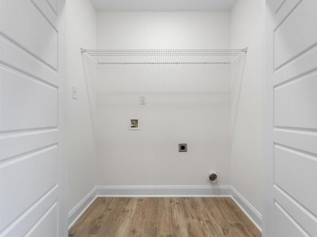 washroom featuring electric dryer hookup, washer hookup, and light wood-type flooring