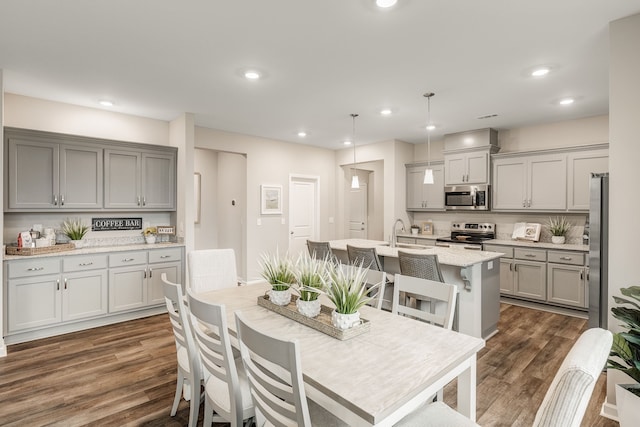 dining room featuring sink and dark hardwood / wood-style flooring