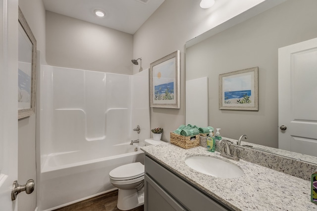 full bathroom with tub / shower combination, toilet, vanity, and hardwood / wood-style floors