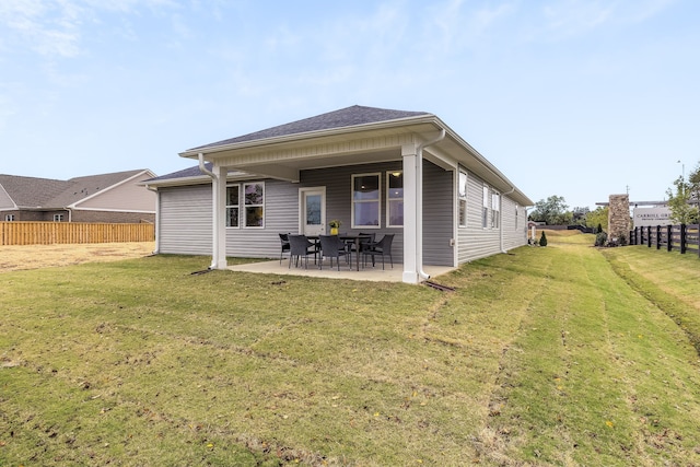 back of house featuring a patio and a lawn