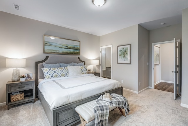 carpeted bedroom featuring ensuite bath