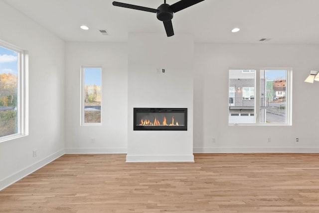 unfurnished living room featuring light hardwood / wood-style floors and ceiling fan