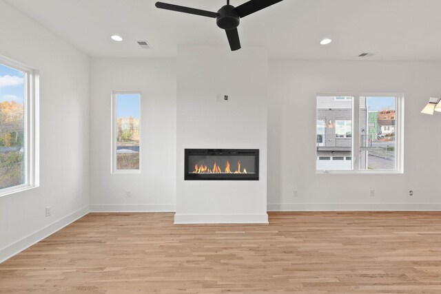 1016 W Trinity Ln Unit 1, Nashville, TN 37218 - unfurnished living room with light wood finished floors, a glass covered fireplace, healthy amount of natural light, and recessed lighting