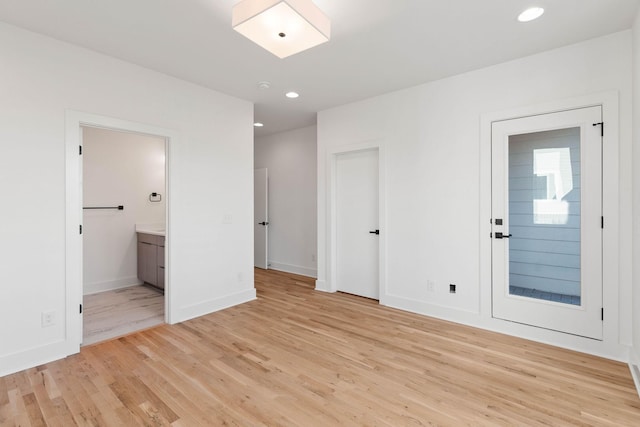 1016 W Trinity Ln Unit 1, Nashville, TN 37218 - unfurnished bedroom featuring light wood-style flooring, ensuite bathroom, and recessed lighting