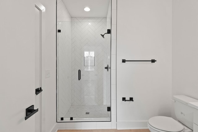 bathroom featuring tile patterned floors, toilet, and walk in shower