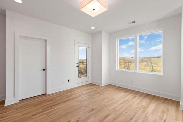 spare room featuring light wood-type flooring