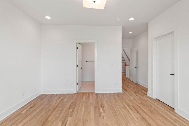 1016 W Trinity Ln Unit 1, Nashville, TN 37218 - spare room with light wood finished floors, stairs, recessed lighting, and a skylight