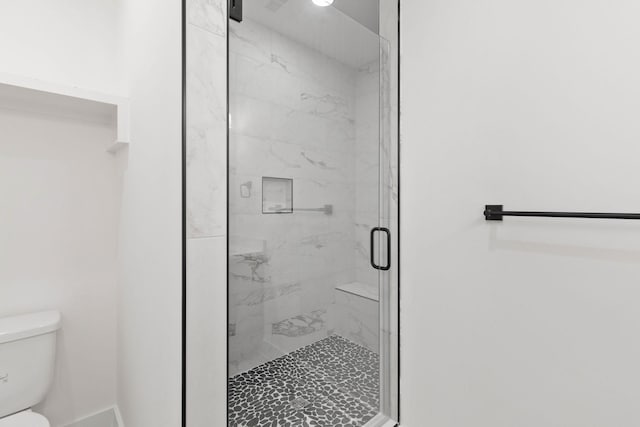 bathroom with toilet and walk in shower