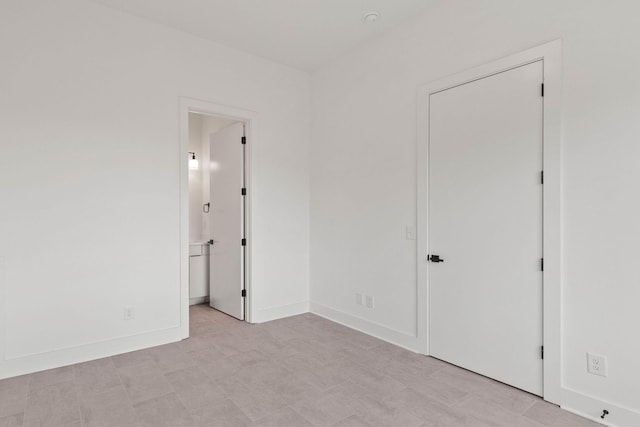 1016 W Trinity Ln Unit 1, Nashville, TN 37218 - unfurnished bedroom with baseboards and connected bathroom