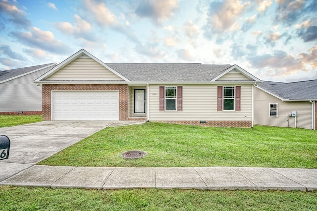 ranch-style home featuring a garage and a front yard