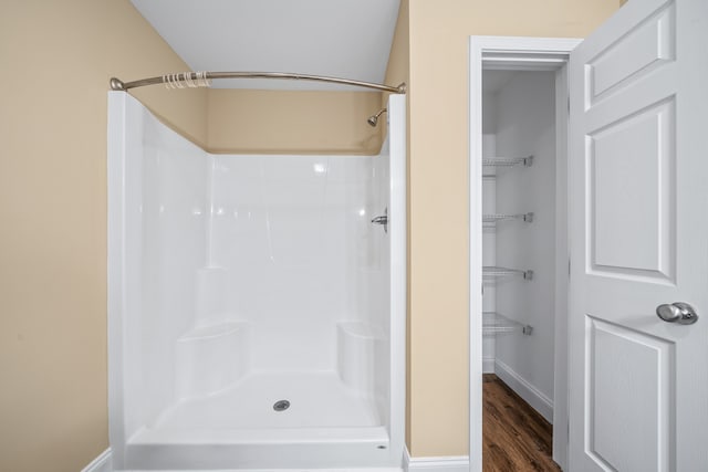 bathroom featuring walk in shower and hardwood / wood-style flooring