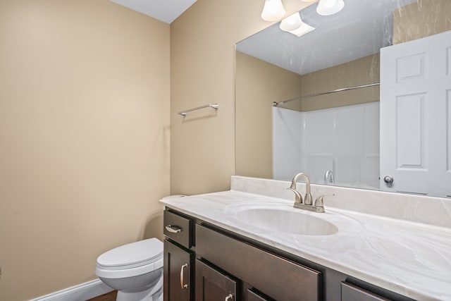 bathroom with toilet and oversized vanity