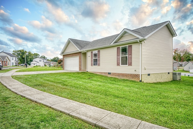 view of front facade with a garage, central AC, and a front lawn