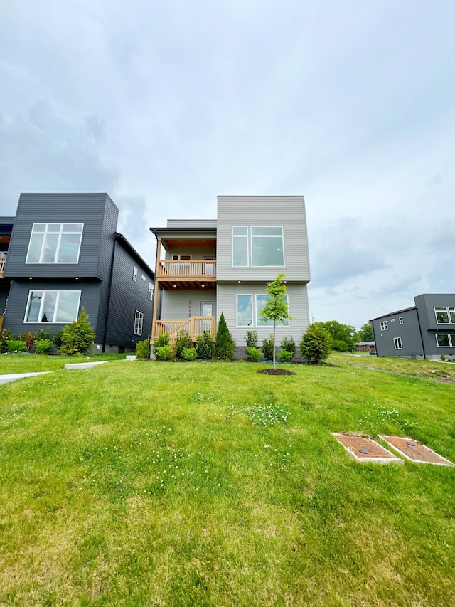 view of front of property featuring a front lawn and a balcony