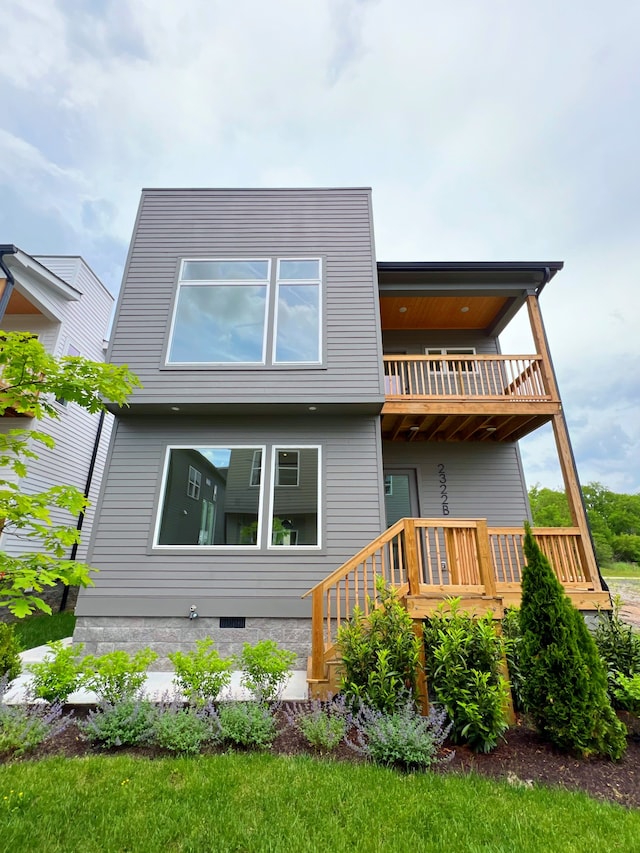 rear view of house featuring a balcony