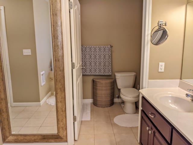 bathroom featuring vanity, toilet, and tile floors