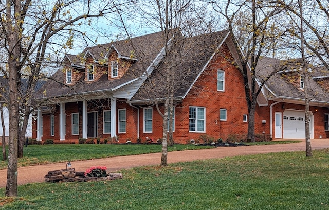 cape cod house with a front lawn and a garage