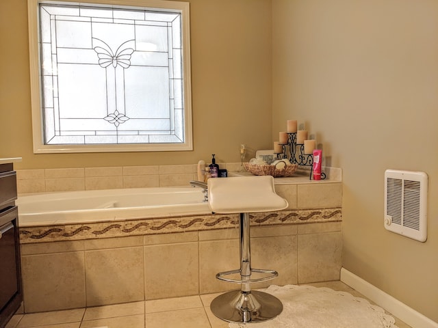 bathroom with tile flooring, plenty of natural light, and tiled bath