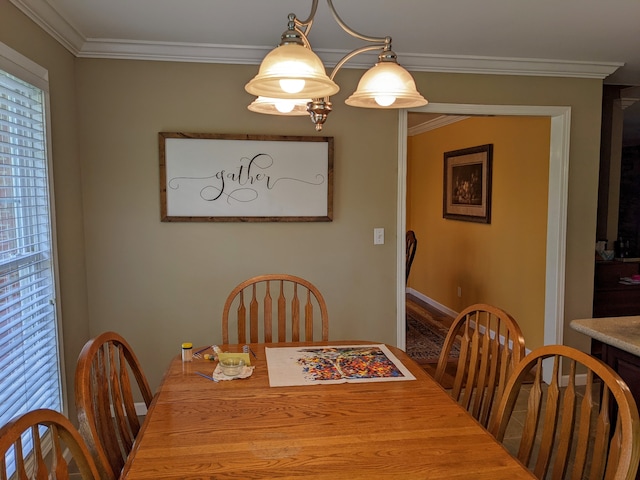 dining space featuring ornamental molding and a chandelier