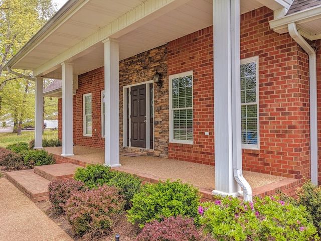 view of exterior entry featuring a porch