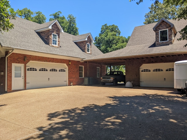 new england style home with a garage and a carport