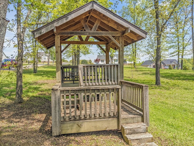 wooden deck featuring a gazebo and a yard