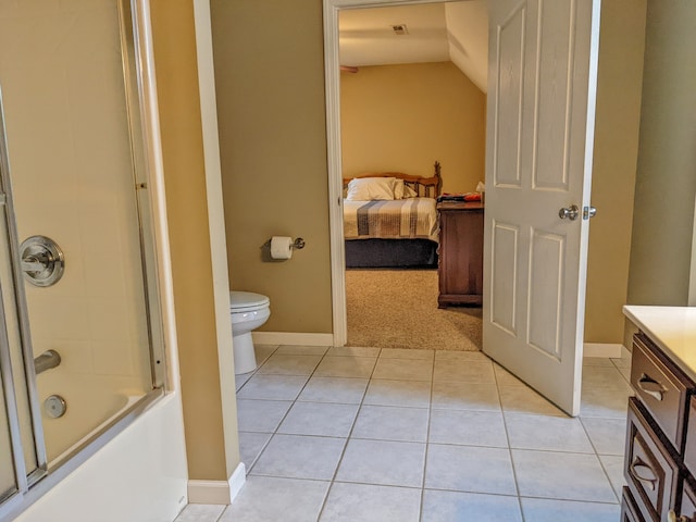 full bathroom featuring tile floors, shower / bath combination with glass door, vanity, and toilet