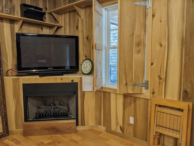 interior space featuring wood walls and hardwood / wood-style flooring