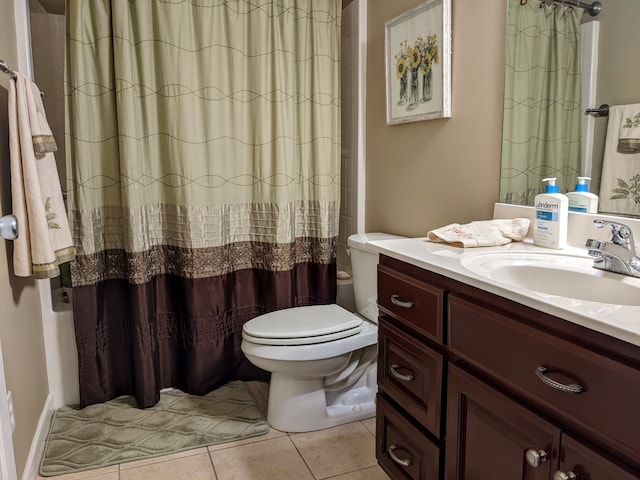 bathroom with tile flooring, large vanity, and toilet