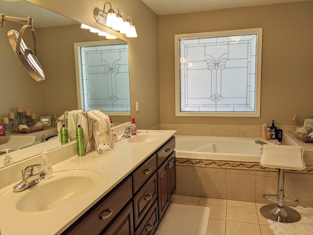 bathroom with tile flooring, tiled bath, and double sink vanity