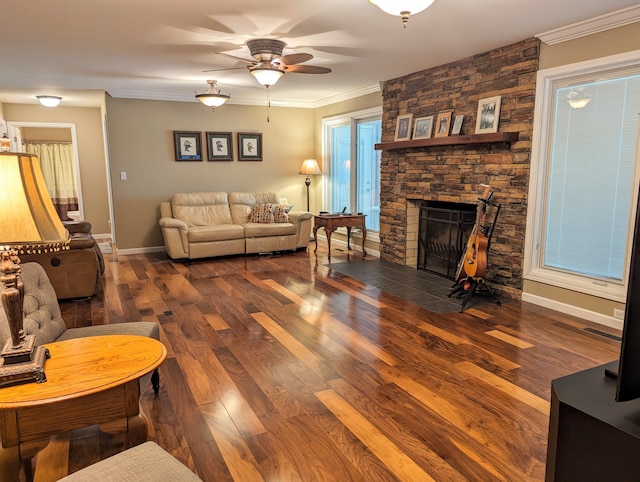 living room with dark hardwood / wood-style flooring, ceiling fan, a fireplace, and crown molding