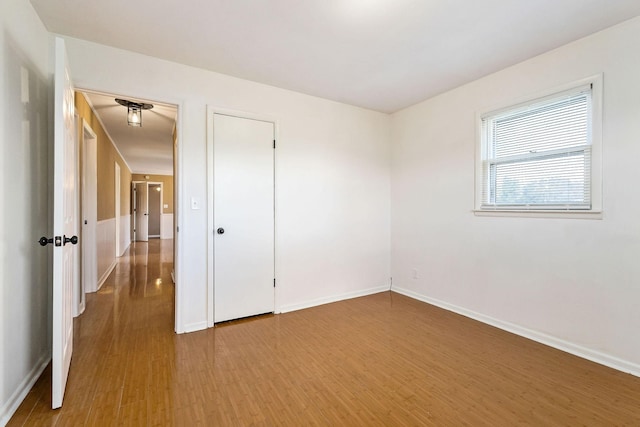 spare room featuring wood-type flooring