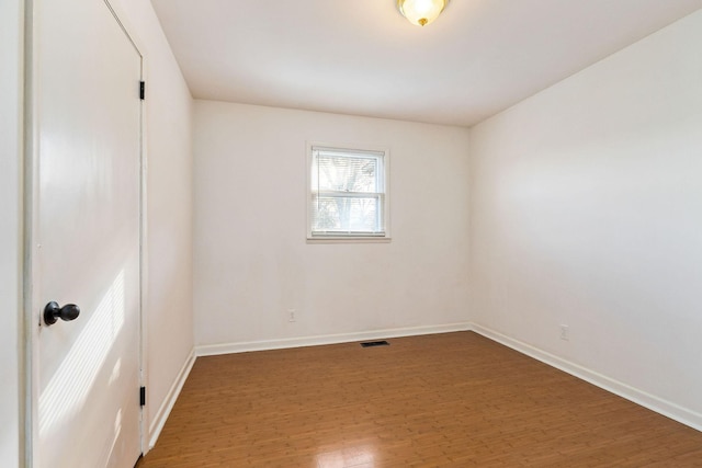 unfurnished room featuring dark wood-type flooring