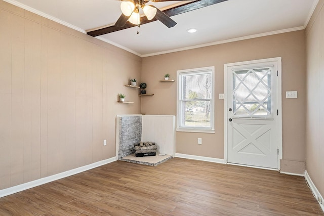 doorway with crown molding, ceiling fan, and light wood-type flooring