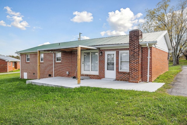 back of property featuring a patio area and a lawn