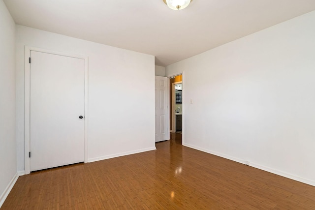 unfurnished bedroom featuring a closet and dark hardwood / wood-style floors