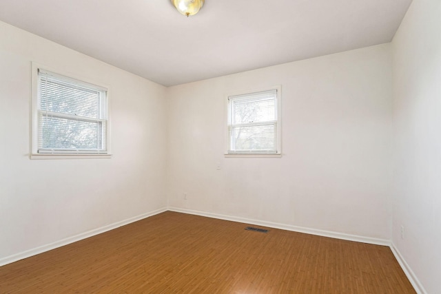 spare room with dark hardwood / wood-style floors