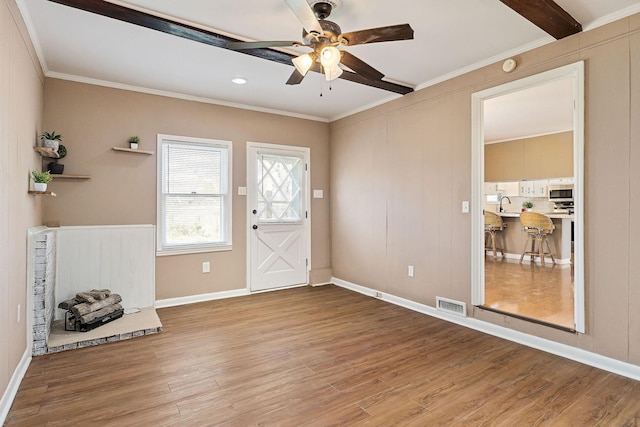 entrance foyer with ceiling fan, crown molding, sink, beam ceiling, and light hardwood / wood-style floors