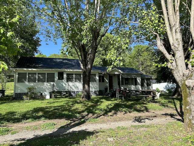 back of property featuring a lawn