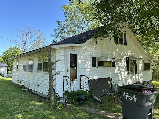 rear view of property with a lawn