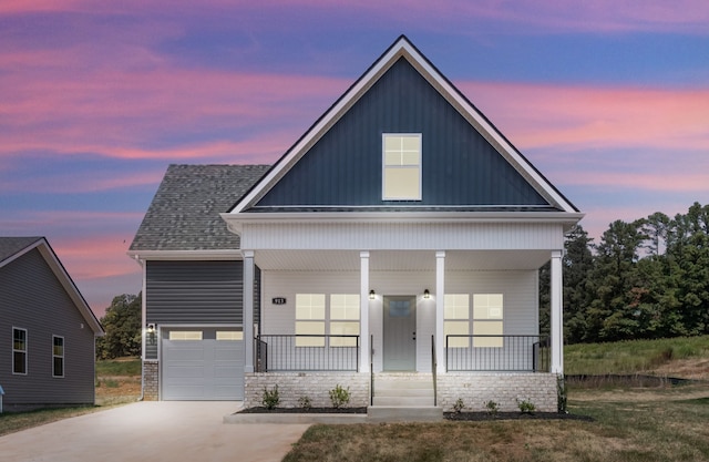 view of front of property featuring a garage and a porch