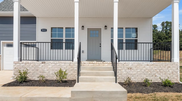 view of exterior entry featuring a porch