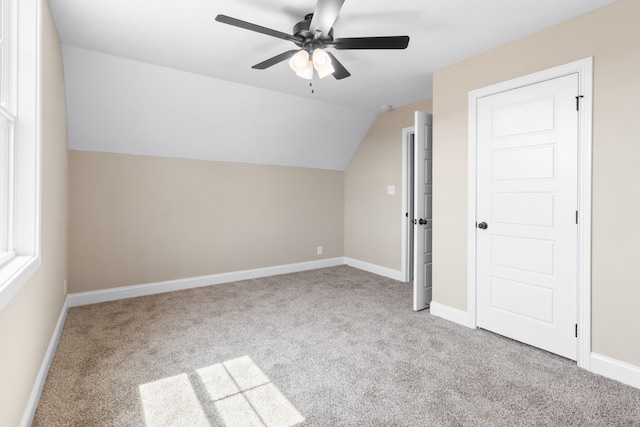 bonus room featuring lofted ceiling, ceiling fan, and light carpet