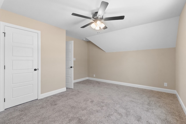 bonus room with lofted ceiling, ceiling fan, and light colored carpet