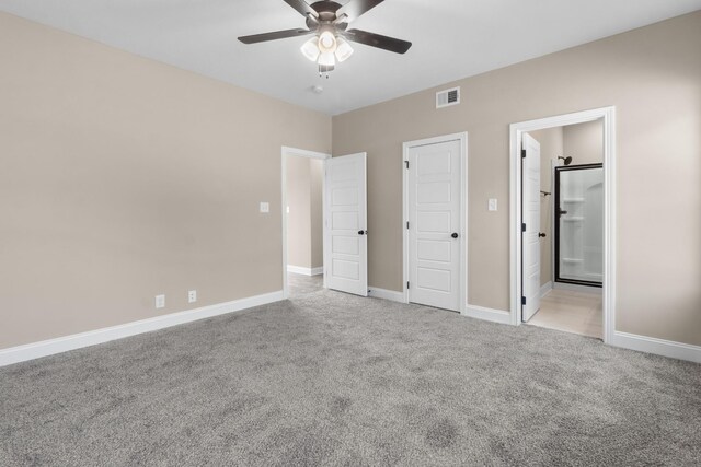 unfurnished bedroom with light colored carpet, connected bathroom, and ceiling fan