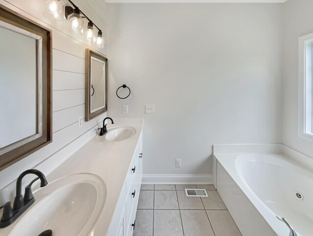 bathroom with tile patterned flooring, vanity, and a bathtub