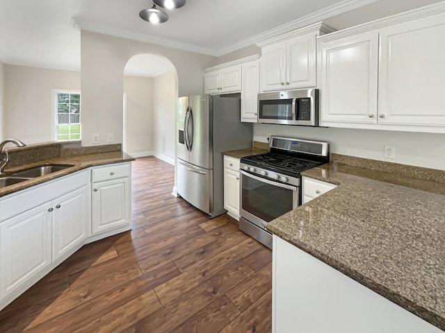 kitchen with white cabinets, appliances with stainless steel finishes, dark hardwood / wood-style flooring, and sink